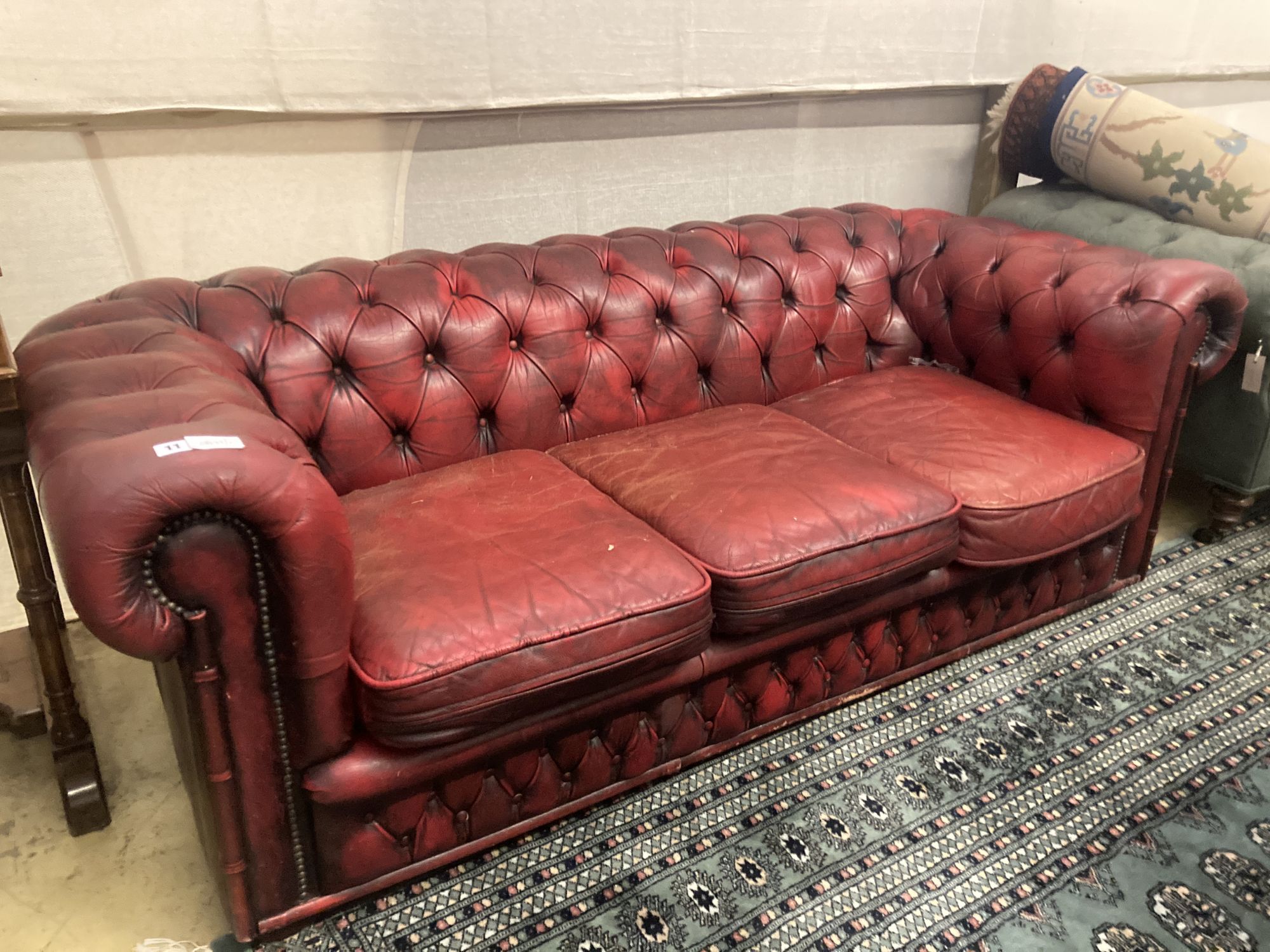 A Victorian style buttoned red leather Chesterfield settee, width 186cm depth 84cm height 66cm